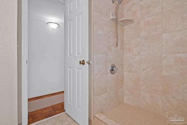 full bath with a tile shower