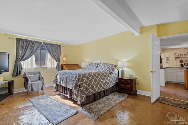 bedroom with vaulted ceiling with beams and baseboards