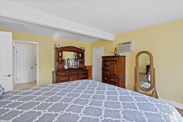 bedroom with a wall unit AC and beam ceiling