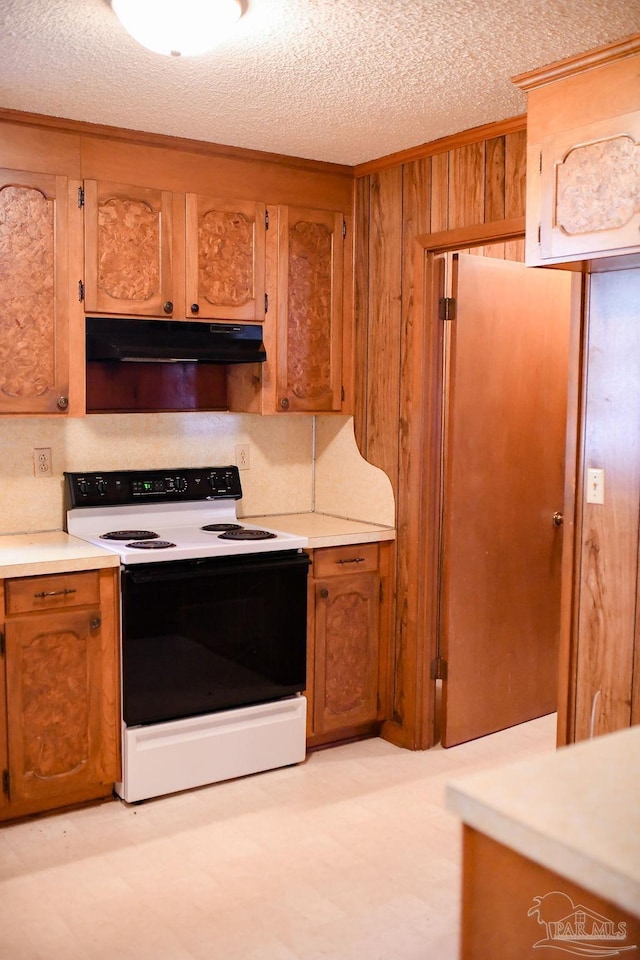 kitchen with wood walls, a textured ceiling, and white electric stove