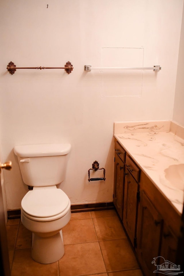 bathroom featuring tile patterned flooring, vanity, and toilet