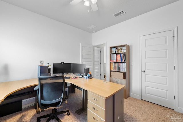 office area featuring visible vents, light carpet, and ceiling fan