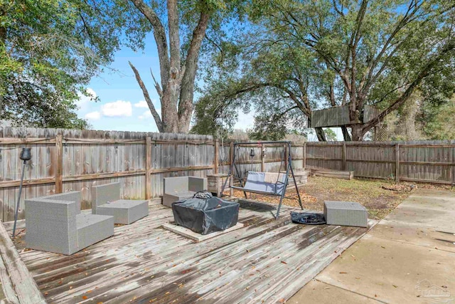 deck featuring an outdoor living space and a fenced backyard