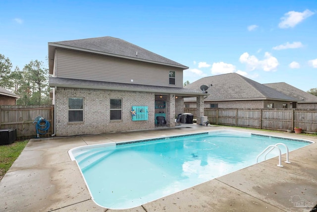 view of swimming pool with a fenced backyard, a fenced in pool, and a patio