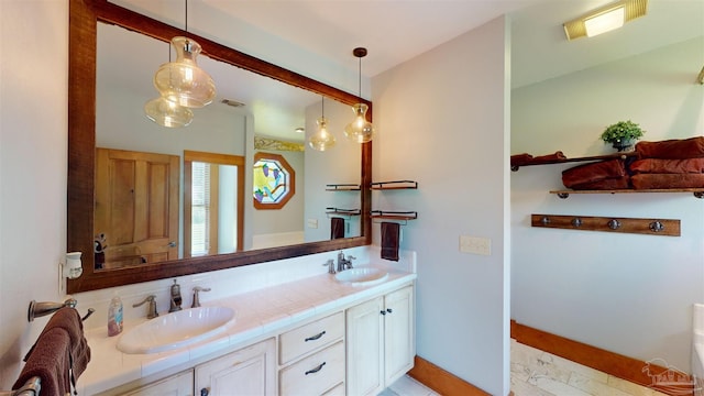 bathroom featuring tile patterned floors and dual bowl vanity