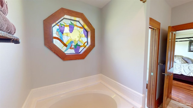 bathroom featuring hardwood / wood-style flooring and a bath