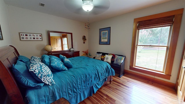 bedroom with ceiling fan and hardwood / wood-style floors