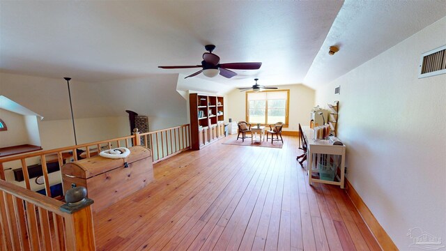 sitting room featuring hardwood / wood-style flooring, vaulted ceiling, and ceiling fan