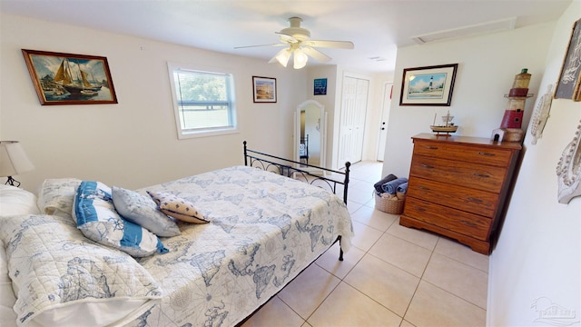 tiled bedroom with a closet and ceiling fan