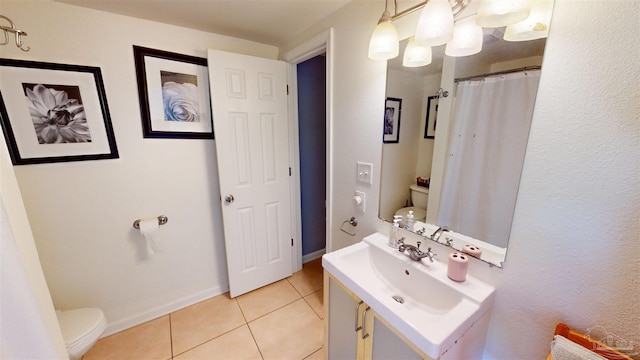 bathroom featuring tile patterned floors, toilet, and vanity