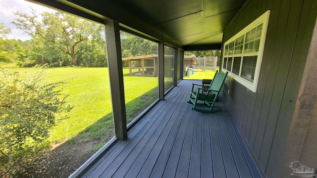 wooden terrace featuring a yard