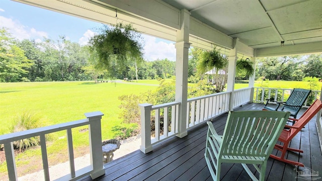 wooden deck with a lawn