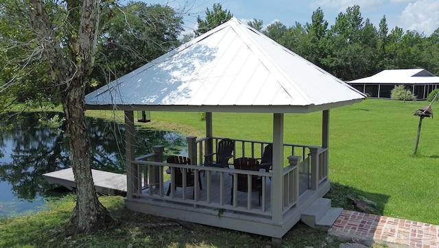 exterior space featuring a water view, a lawn, and a gazebo