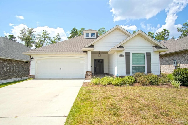 craftsman-style house with concrete driveway, a front lawn, roof with shingles, and a garage