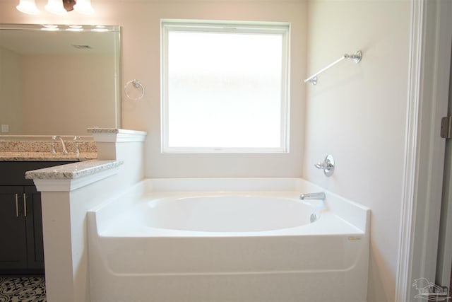 bathroom featuring vanity and a bath