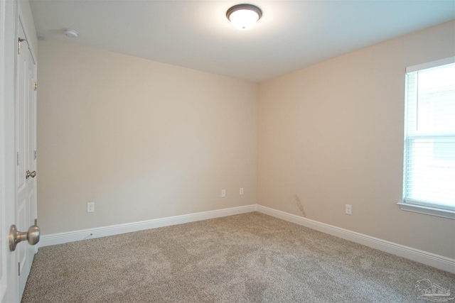 empty room with light carpet and baseboards