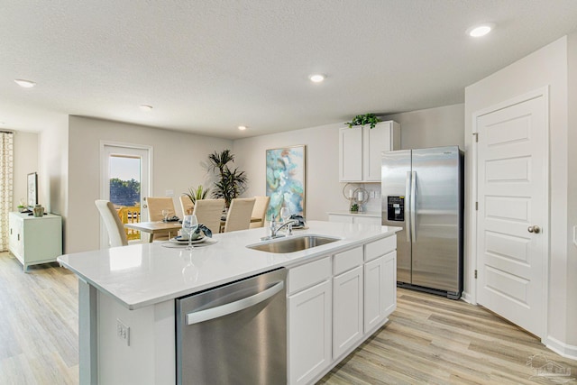2766 Chevy Cir, Pace, FL 32571 - kitchen featuring stainless steel appliances, a center island with sink, light countertops, white cabinetry, and recessed lighting