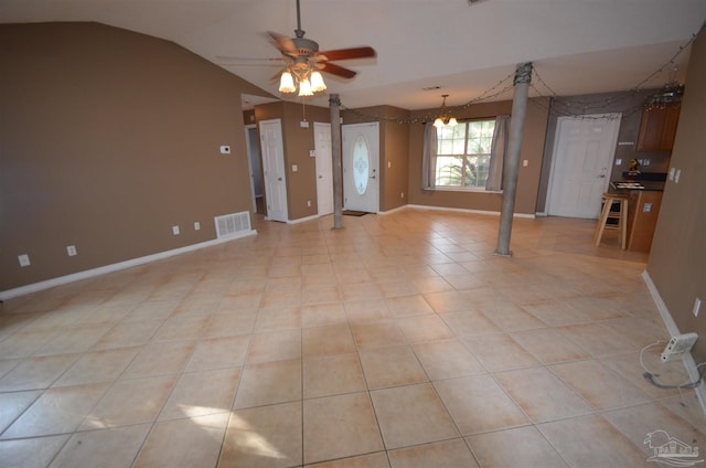 empty room featuring a ceiling fan, baseboards, visible vents, and lofted ceiling