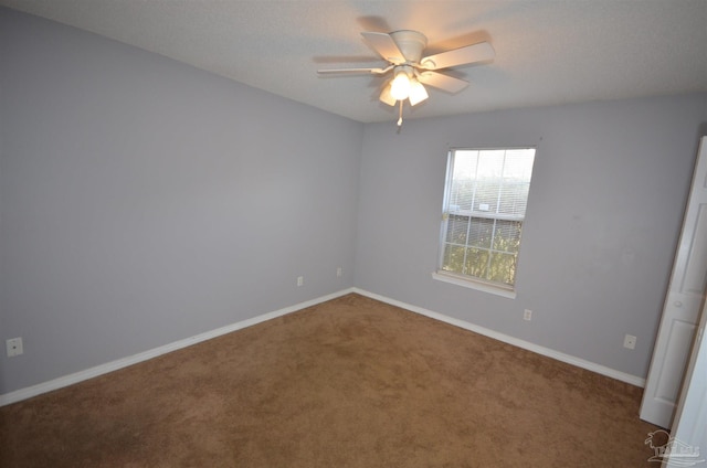 unfurnished room with carpet floors, baseboards, and a ceiling fan