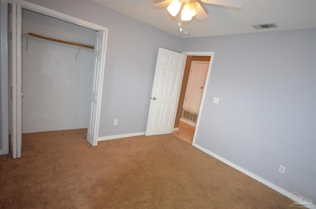 unfurnished bedroom with visible vents, baseboards, carpet floors, and a closet