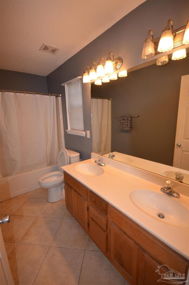 bathroom with visible vents, a sink, tile patterned floors, and toilet