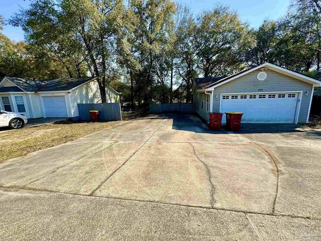 view of side of home featuring an attached garage and driveway