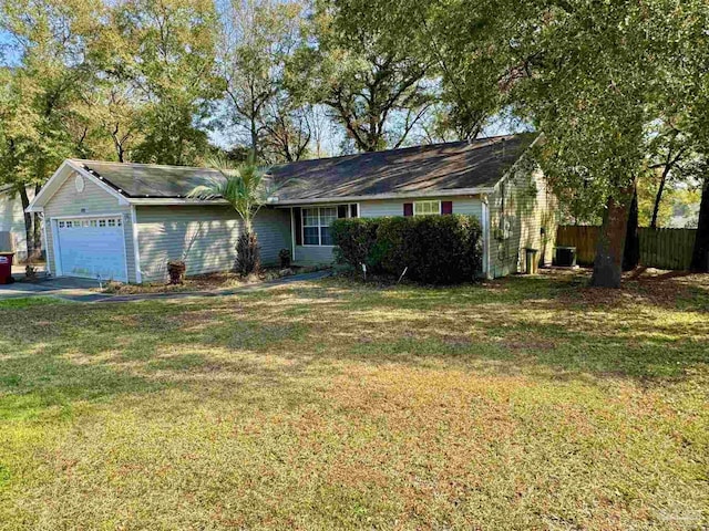 single story home with an attached garage, fence, central AC unit, and a front yard