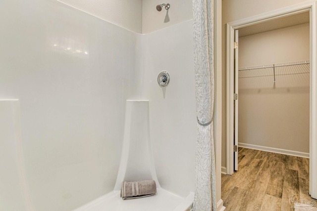 bathroom with a shower and hardwood / wood-style floors