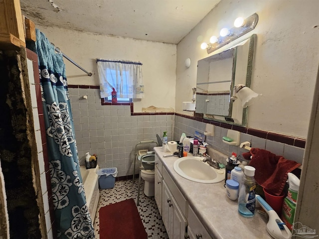 full bathroom with tile walls, toilet, shower / bath combo, and vanity