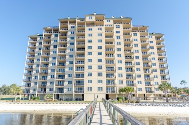 view of property with a water view and a view of the beach