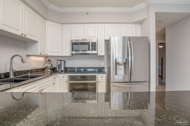 kitchen with white cabinets, dark stone countertops, sink, and appliances with stainless steel finishes