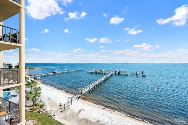 property view of water featuring a boat dock and a beach view