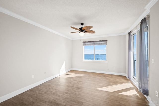 empty room with a water view, ornamental molding, and light wood-type flooring