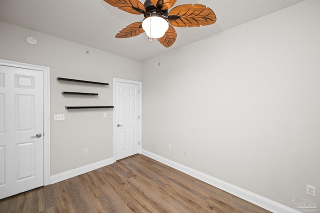 unfurnished bedroom featuring wood-type flooring and ceiling fan