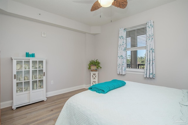 bedroom featuring wood-type flooring, a textured ceiling, and ceiling fan