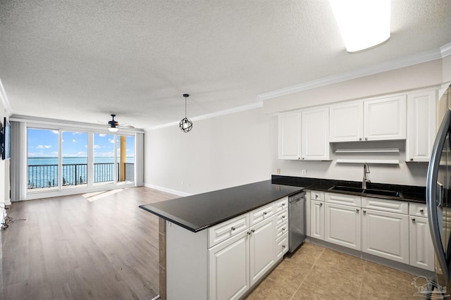 kitchen with white cabinets, crown molding, sink, ceiling fan, and kitchen peninsula