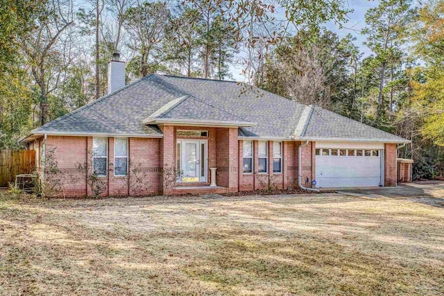 ranch-style home with a garage and a front yard