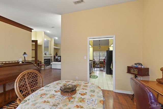 dining area with built in shelves, dark hardwood / wood-style floors, and a tile fireplace