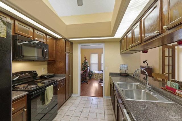 kitchen featuring light tile patterned flooring, ceiling fan, sink, and black appliances