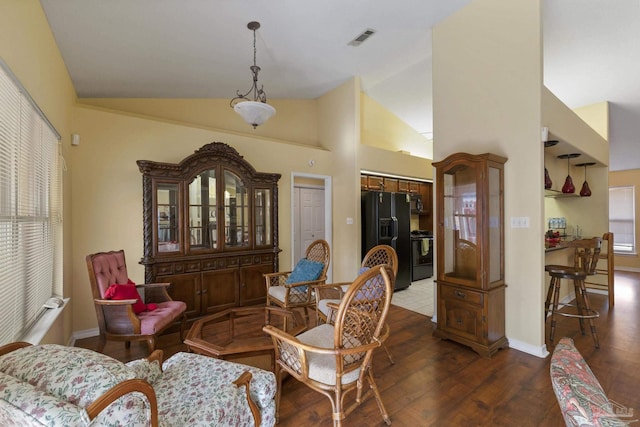 living area with lofted ceiling and dark hardwood / wood-style flooring