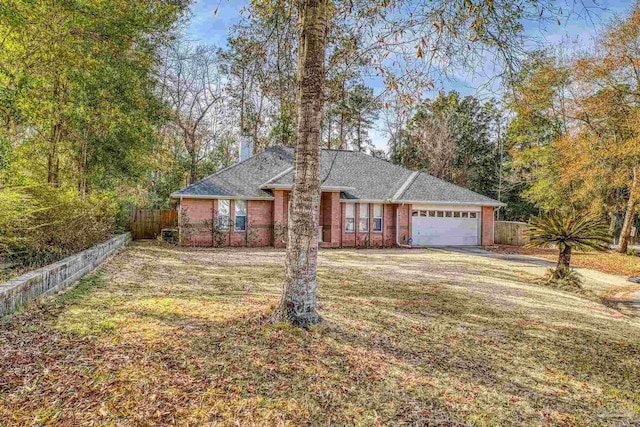 single story home featuring a garage and a front yard