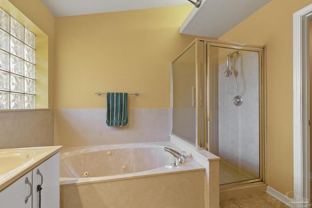 bathroom featuring shower with separate bathtub and vanity