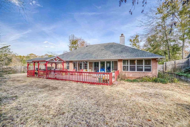 rear view of house featuring a lawn