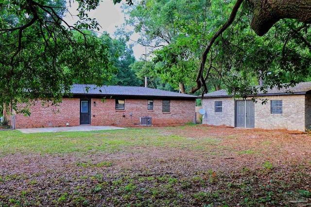 5197 Avenida Del Fuego, Pace, FL 32571 - rear view of house with brick siding, a patio, and a yard