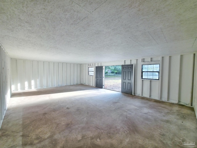 5197 Avenida Del Fuego, Pace, FL 32571 - spare room featuring unfinished concrete flooring and a textured ceiling