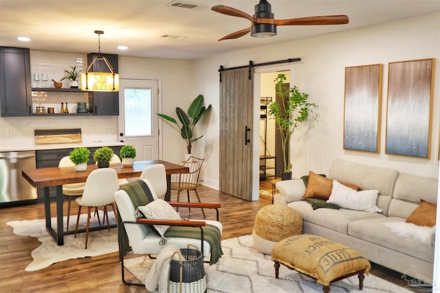 5197 Avenida Del Fuego, Pace, FL 32571 - living area with a barn door, wood finished floors, recessed lighting, ceiling fan, and a chandelier