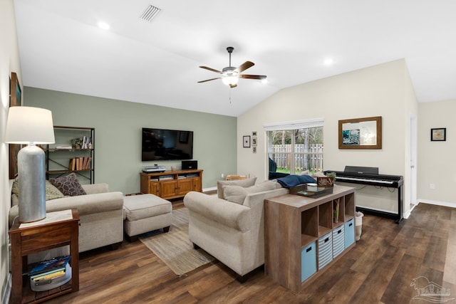 living area featuring visible vents, a ceiling fan, dark wood finished floors, baseboards, and vaulted ceiling