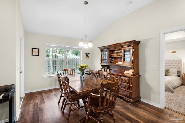 dining space featuring baseboards, lofted ceiling, an inviting chandelier, and dark wood-style floors