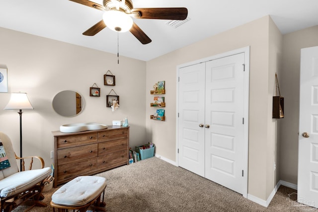 living area featuring ceiling fan, baseboards, and carpet