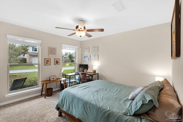 bedroom featuring visible vents, baseboards, carpet, and a ceiling fan